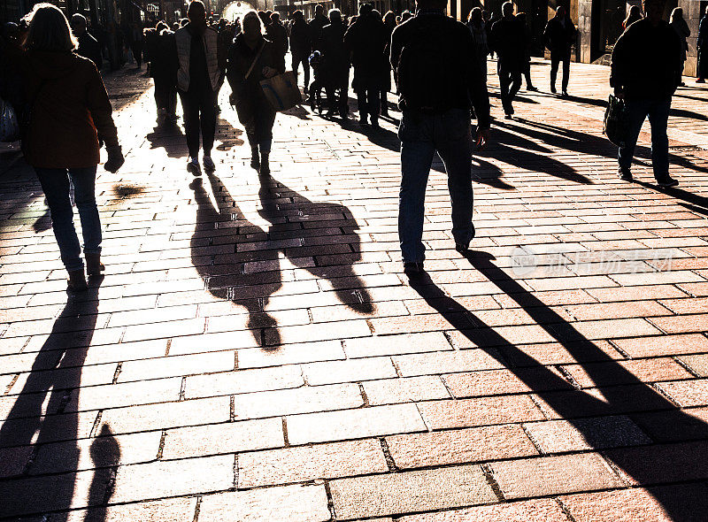 Silhouetted high street shoppers